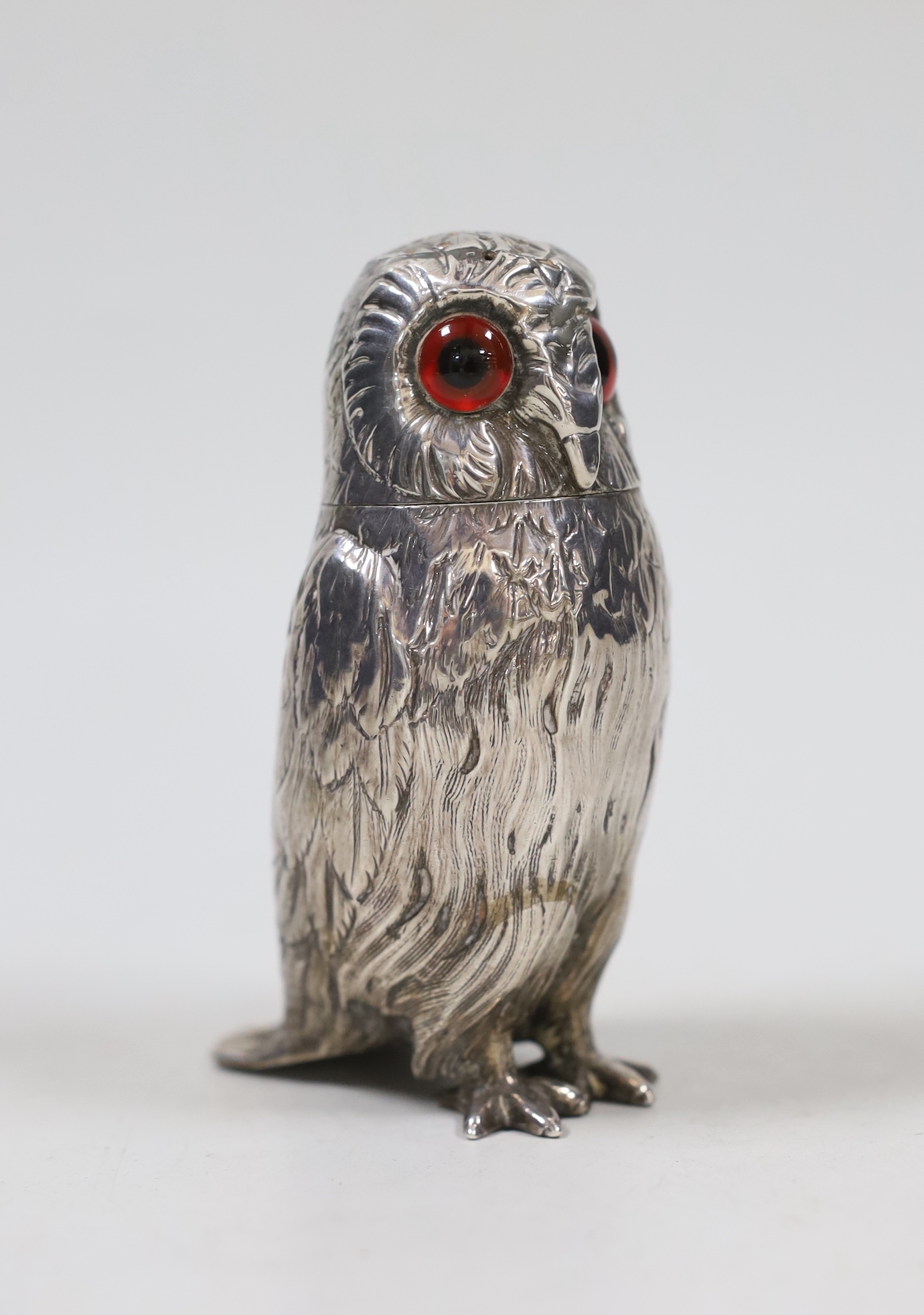 A Victorian novelty silver condiment, modelled as an owl with glass eyes, George John Richards, London, 1853, 9.9cm.